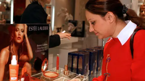 Getty Images A lady looking at Estee Lauder make up