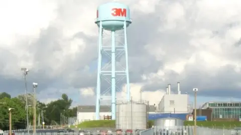 Geograph/ Nigel Davies A water tower with the logo "3M" on it on a factory site, with a cloudy sky visible in the photograph 